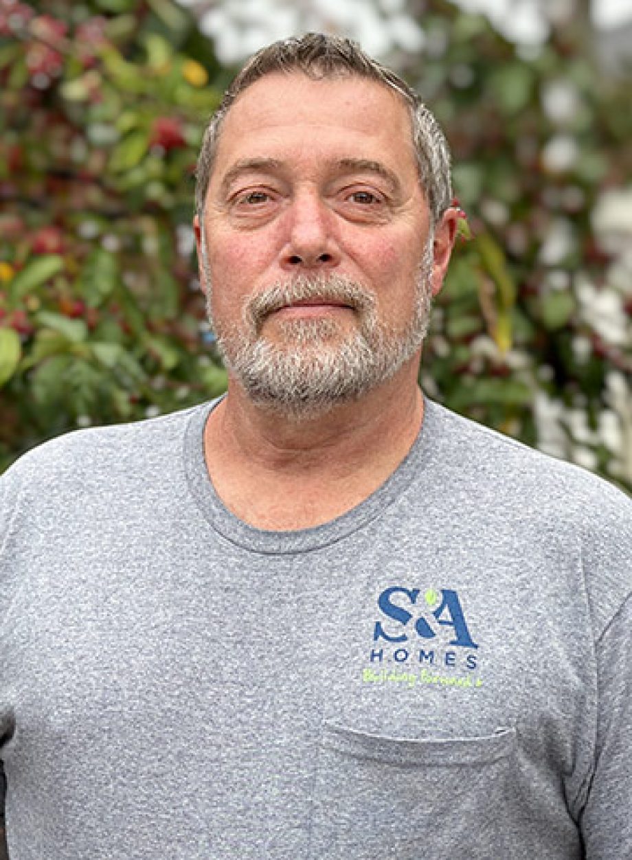 Rich Jones standing outdoors in a gray S&A Homes t-shirt